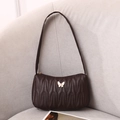 Dark brown quilted underarm bag featuring a wave pattern and cream butterfly detail - Coffee