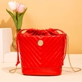 Red quilted bucket bag with golden chain strap and round metal logo on cream base - Red