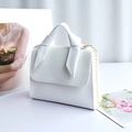 White PU leather crossbody bag with knot handle and gold chain strap in variant style - White