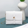 Elegant white square crossbody bag with gold round buckle and chain strap on textured surface - White