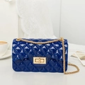 Royal blue jelly square bag with gold chain and quilted texture in a stylish setting - Blue