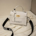 White patent leather handbag with gold twist lock and stylish lettered crossbody strap - White