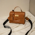 Glossy brown mini Kelly style phone bag with printed text and wide black strap - Brown