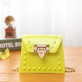 Vibrant yellow jelly crossbody bag featuring gold rivets and elegant chain strap - Yellow