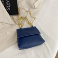 Navy blue crossbody bag with gold chunky chain handle and long chain strap on beige blazer - Blue