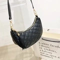 Chic black quilted crescent shoulder bag with golden hardware and fringe tassel detail - Black