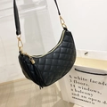 Black quilted crescent moon bag with elegant tassel and gold-tone hardware detail - Black