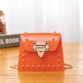 Mini orange jelly crossbody bag with polished rivets and a light gold chain strap - Orange