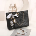 Black quilted triangle shoulder bag with metal chain strap and decorative silk scarf - Black