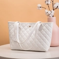 White quilted faux leather tote bag featuring a gold metal clasp and elegant handles - White