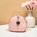 Pink round crossbody bag with quilted rhombic pattern and a black cat charm - Pink