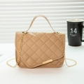 Chic khaki quilted crossbody bag with gold hardware and chain strap on a desk - Khaki