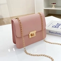 Pink crossbody chain bag with gold lock and polished leather finish on white surface - Pink