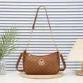Retro brown monogram crossbody bag with golden M logo and chain strap on woven mat - Yellow