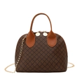Vintage brown monogram shell handbag with gold chain strap and top handle design - Patterned