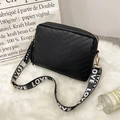 Black quilted crossbody camera bag with tassel and LOVE jacquard wide strap on plush rug - Black