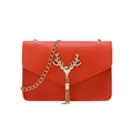 Red crossbody bag with textured leather, golden deer head emblem, and metal tassels - Red
