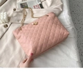 Detail of pink quilted bucket bag with crown pearl charm and gold chain strap - Pink