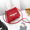 Structured red crossbody bag with gold metal clasp on white surface with Kinfolk decor - Red