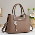 Detail of brown woven texture handbag with leather handles and silver metal charm pendant - Dark Khaki