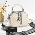 Chic beige quilted crossbody handbag with silver bear charm and striped wide shoulder strap - Off White