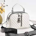White quilted crossbody bag with dual zippers, bear charm and wide patterned strap - White