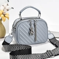 Light blue quilted shoulder bag with silver bear charm and stylish herringbone strap - Blue