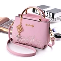Pink faux leather handbag with floral embroidery and gold circular metal handle - Light Purple