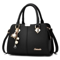 Classic black litchi pattern leather handbag for women with elegant golden floral pendant - Black