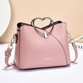 Pink heart-handle crossbody bag with adjustable strap and designer stitching detail - Pink