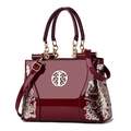 Retro burgundy patent leather handbag with floral embroidery and gold hardware accents - Fuschia