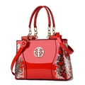 Red glossy patent leather handbag with double-sided floral embroidery and golden hardware - Red