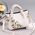 Creamy white leather handbag with floral embroidery and woven top handle for women - Off White
