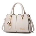 Chic beige lychee leather handbag with golden floral charm and crossbody strap - White