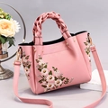 Elegant pink PU leather handbag with floral embroidery and woven top handle details - Pink