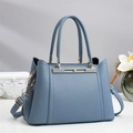 Close-up of fog blue tote bag showing premium lychee texture and gold metal details - Blue