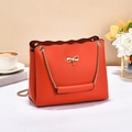 Leuchtend orangefarbene Tasche mit Wellenrand, goldener Schleife und Kettenriemen - Rot