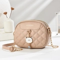 Detail of nude pink quilted bag featuring a cat pendant and gold chain strap - Khaki