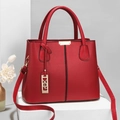 Red pebbled leather handbag with gold metal bar accent and adjustable long strap - Burgundy
