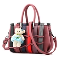 Women's woven faux leather handbag in dark pink with multicolor strips and bear charm - Dusty Rose