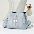 Light blue herringbone bucket bag with stylish jacquard strap and bow charm detail - Blue