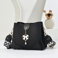 Black textured bucket bag with leather trim, golden chain and white bow charm - Black