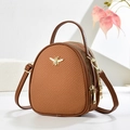 Brown mini crossbody handbag with golden bee accent and textured weave detail - Earthy Yellow