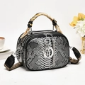Python print leather handbag with scarf handle and vintage wide strap on white background - Black