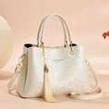 Beige floral embossed leather handbag for women with top handles and tassel charm - Off-white