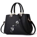 Elegante borsa a mano in pelle nera con ricami floreali blu e gialli e doppi manici - Classico / Nero