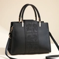 Elegant black leather handbag with rose embroidery and gold-toned hardware detail - Black