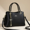 Elegant black leather handbag for women with gold hardware and heart-shaped pendant - Black