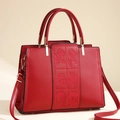Elegant red leather handbag with floral rose embroidery and gold-tone hardware detail - Red