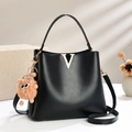 Fashionable black matte leather bucket bag with gold V logo and cute plush charm pendant - Black